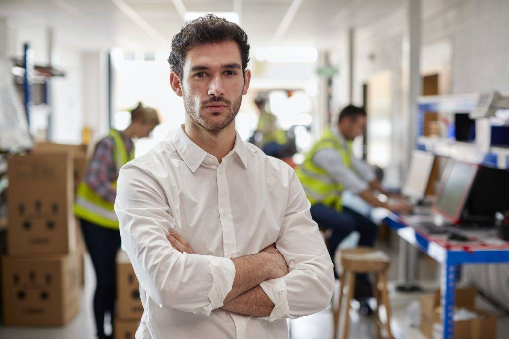 portrait of male manager in logistics distribution warehouse