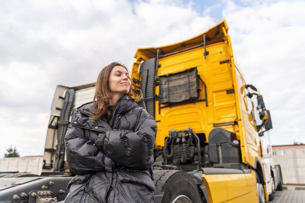 caucasian young woman driving truck trucker female worker transport industry occupation