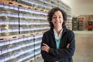 portrait of an african american female manager in a storage warehouse of pallets