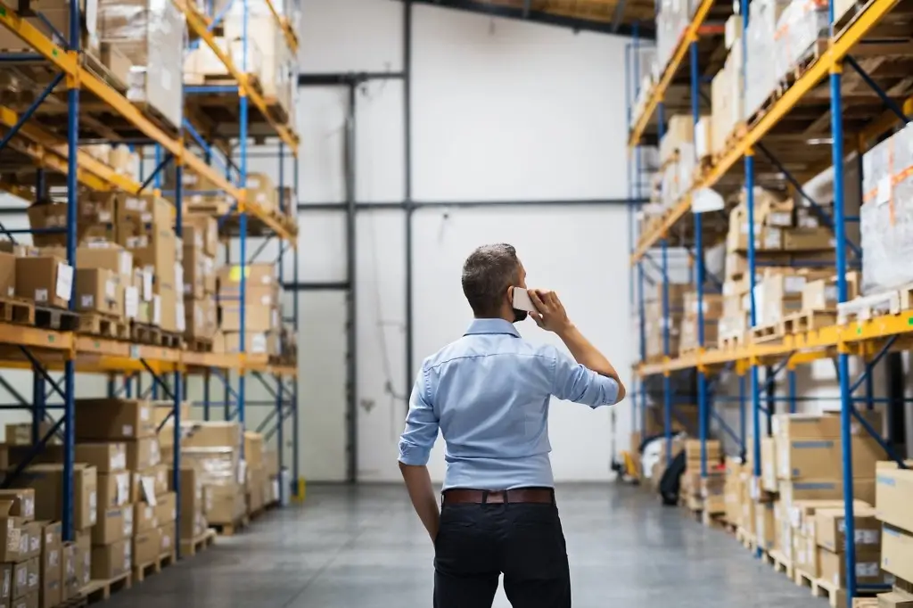 warehouse worker or supervisor with a smartphone
