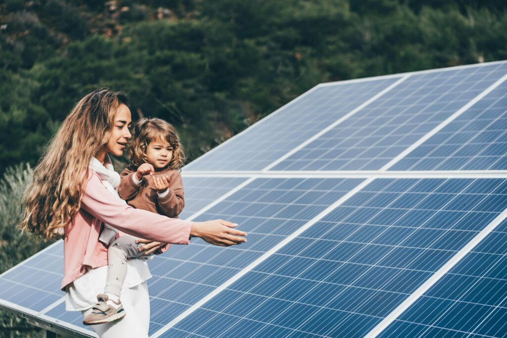 Mother teaching her daughter about sustainable energy and environmental consciousness.
